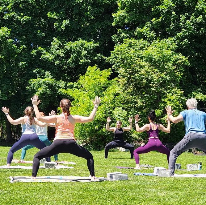 Group doing yoga outside at a farm